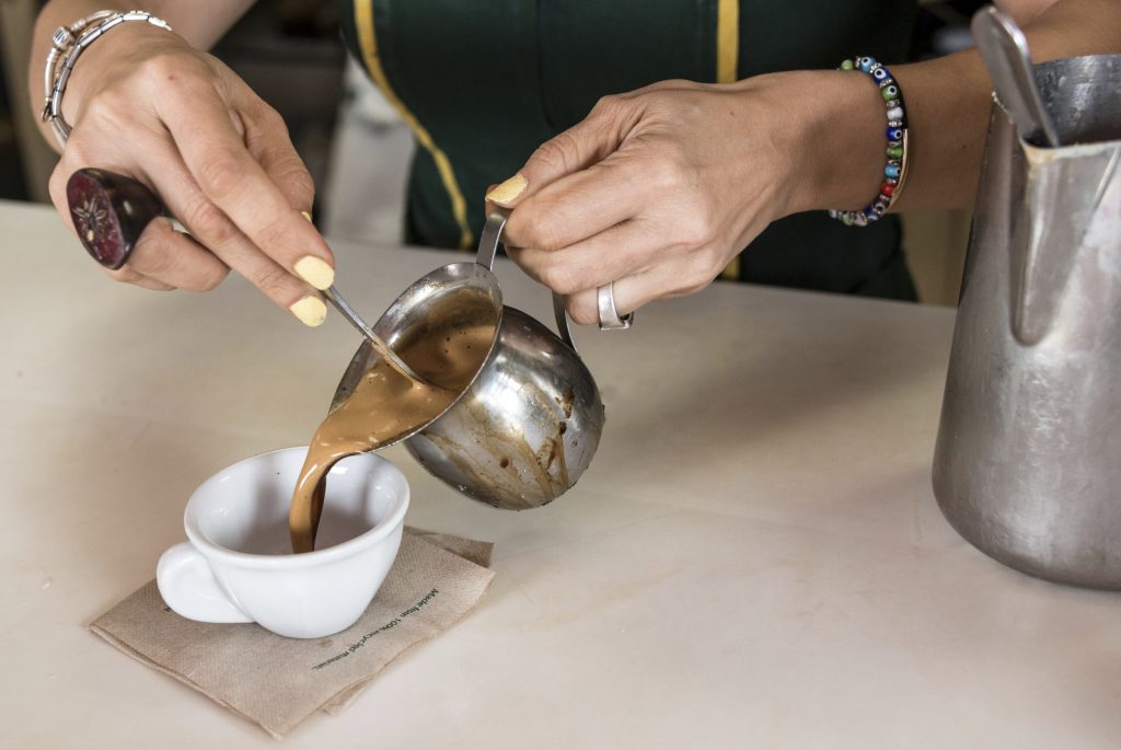 Woman serving a cuban expresso coffee